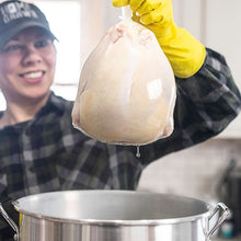 Load image into Gallery viewer, Woman  holding a chicken wrapped in an FPSB
